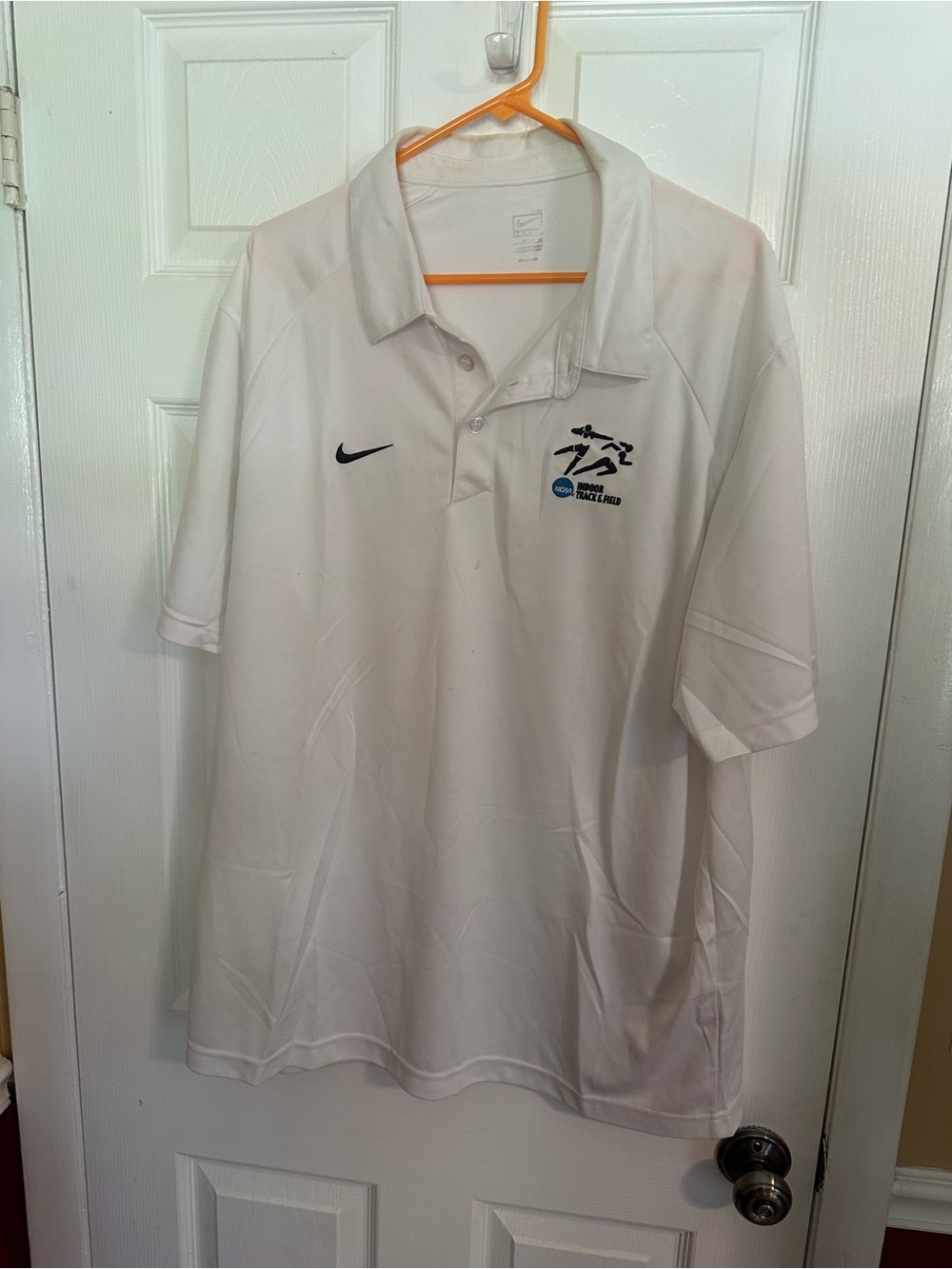 NCAA White Polo Shirt with Nike Swoosh and Track Logo